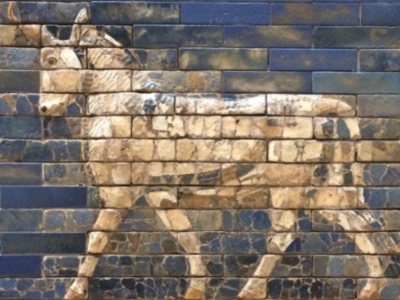 A mural of a pack animal on a brick wall.