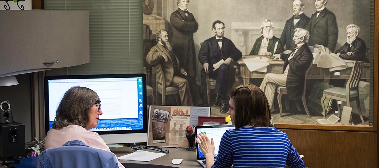 A student working with a librarian.