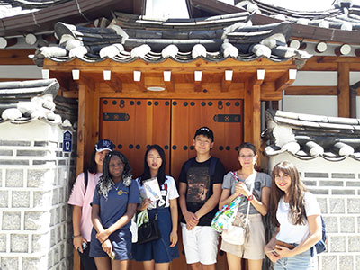 Students posing outside a building in Seoul.