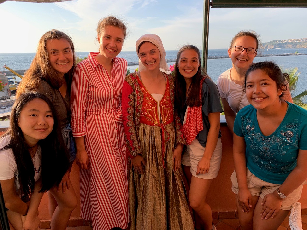 A group photo with the ocean in the background.