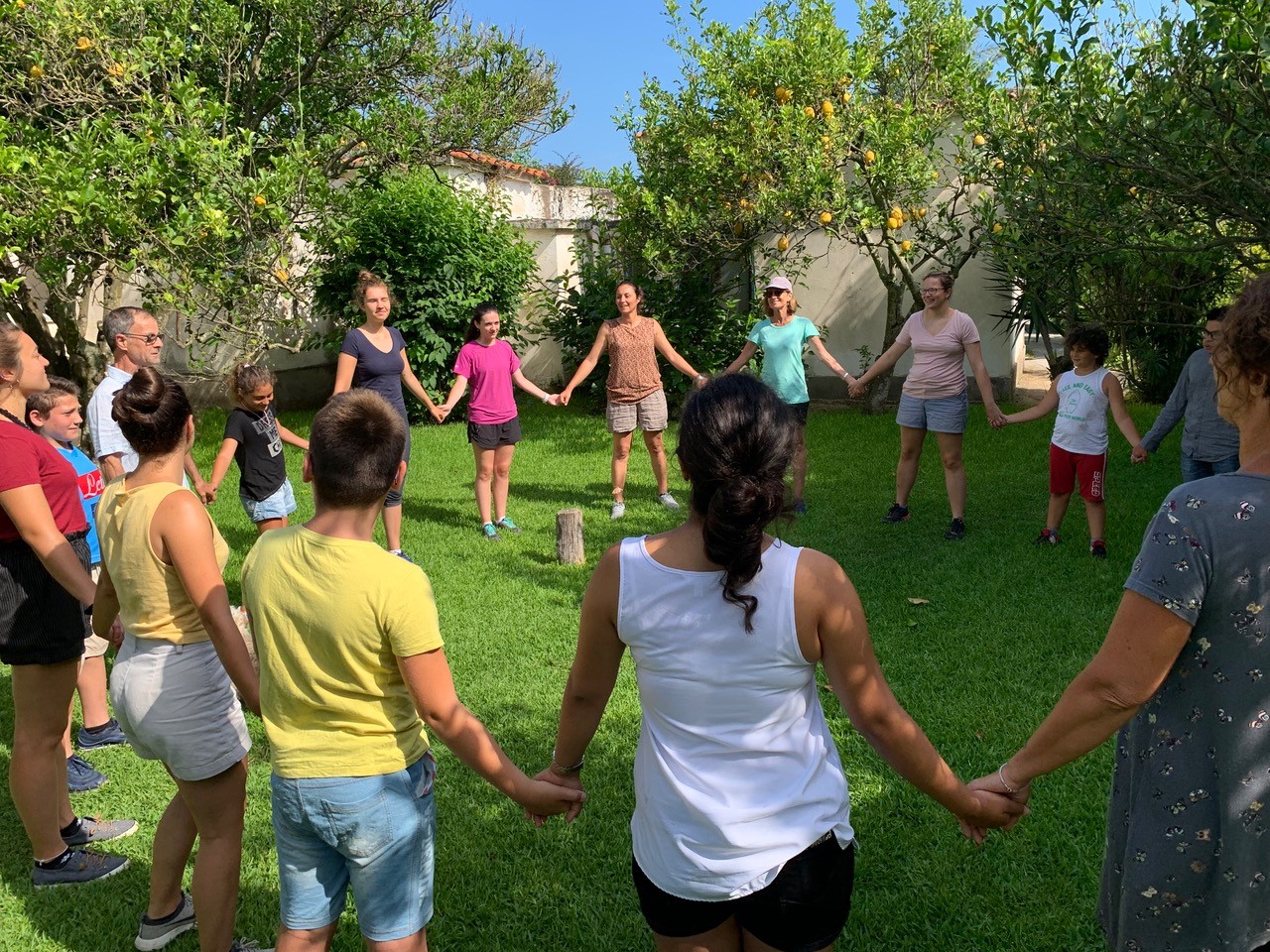 A group of students holding hands in a circle.