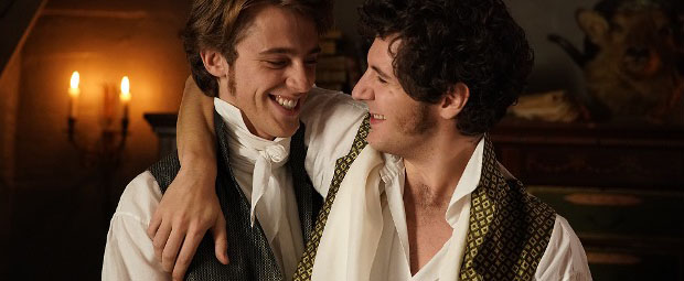 A still image from the movie of a two men smiling and embracing each other.
