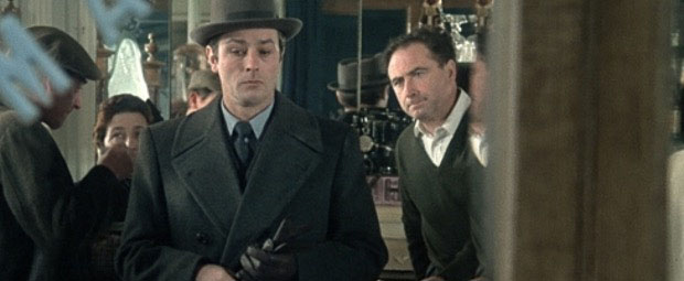 A still image from the movie of a man looking despondent as he exits a store.