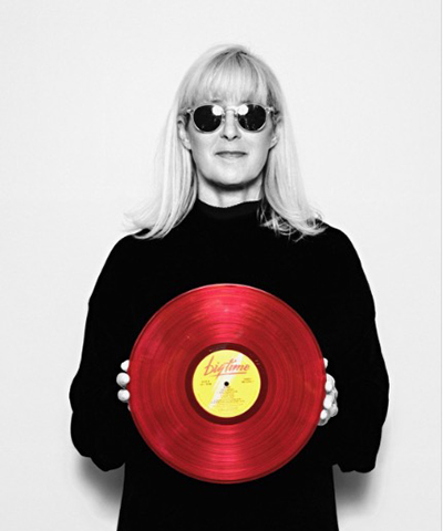 Joanna Stingray holding a red record.