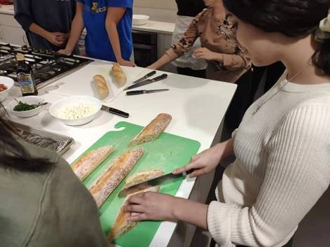 A student slicing bread.