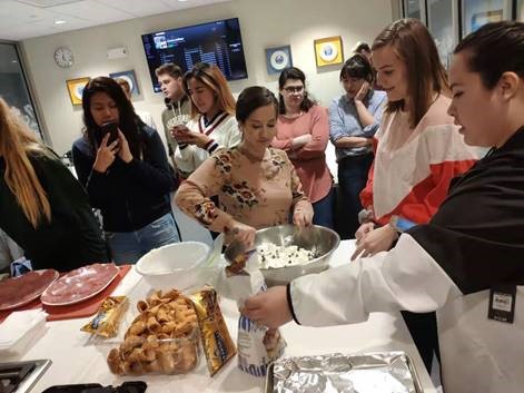 Students sampling food.