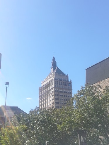 building and trees against blue sky