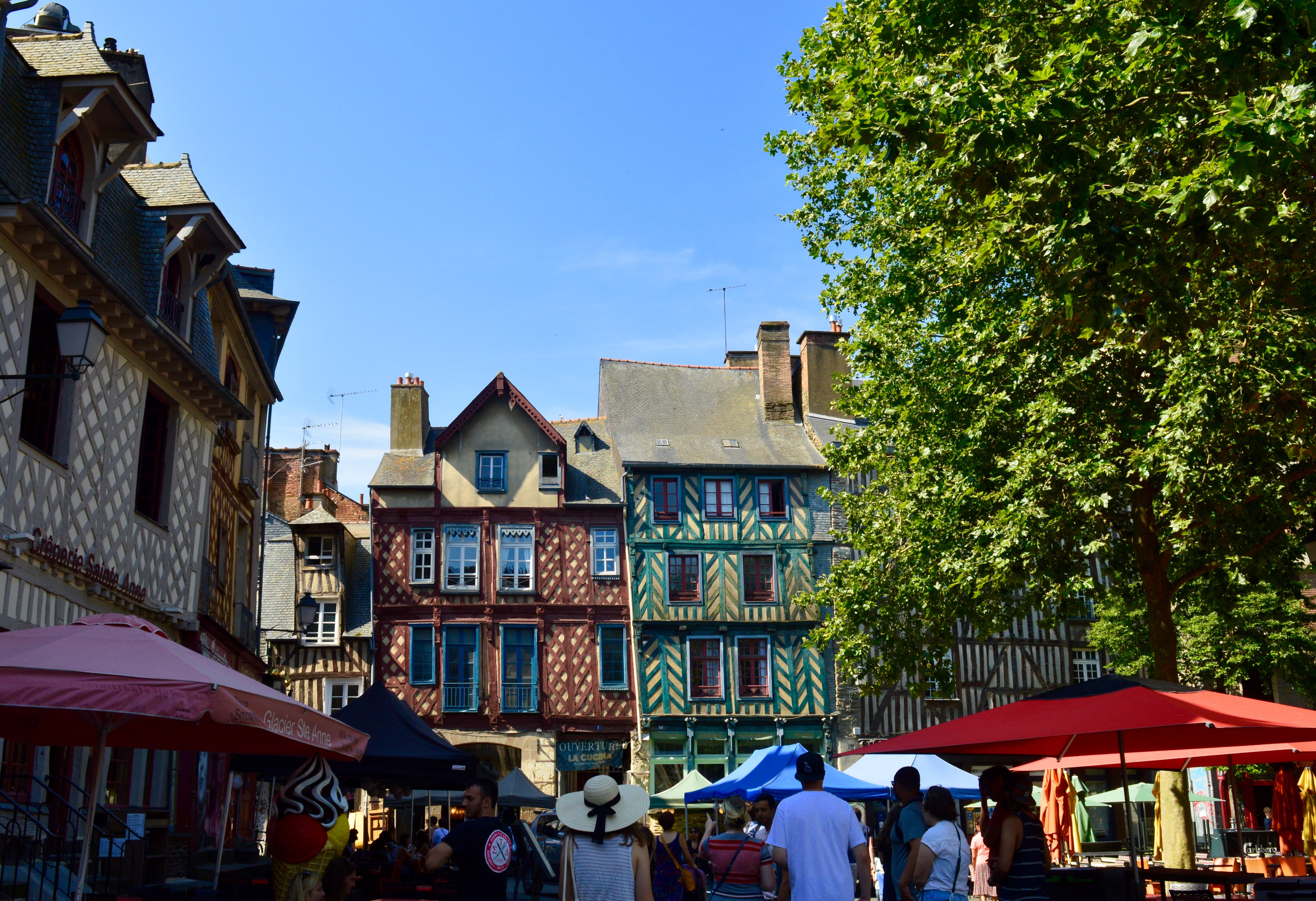 open air market with old buildings with decorative striped walls