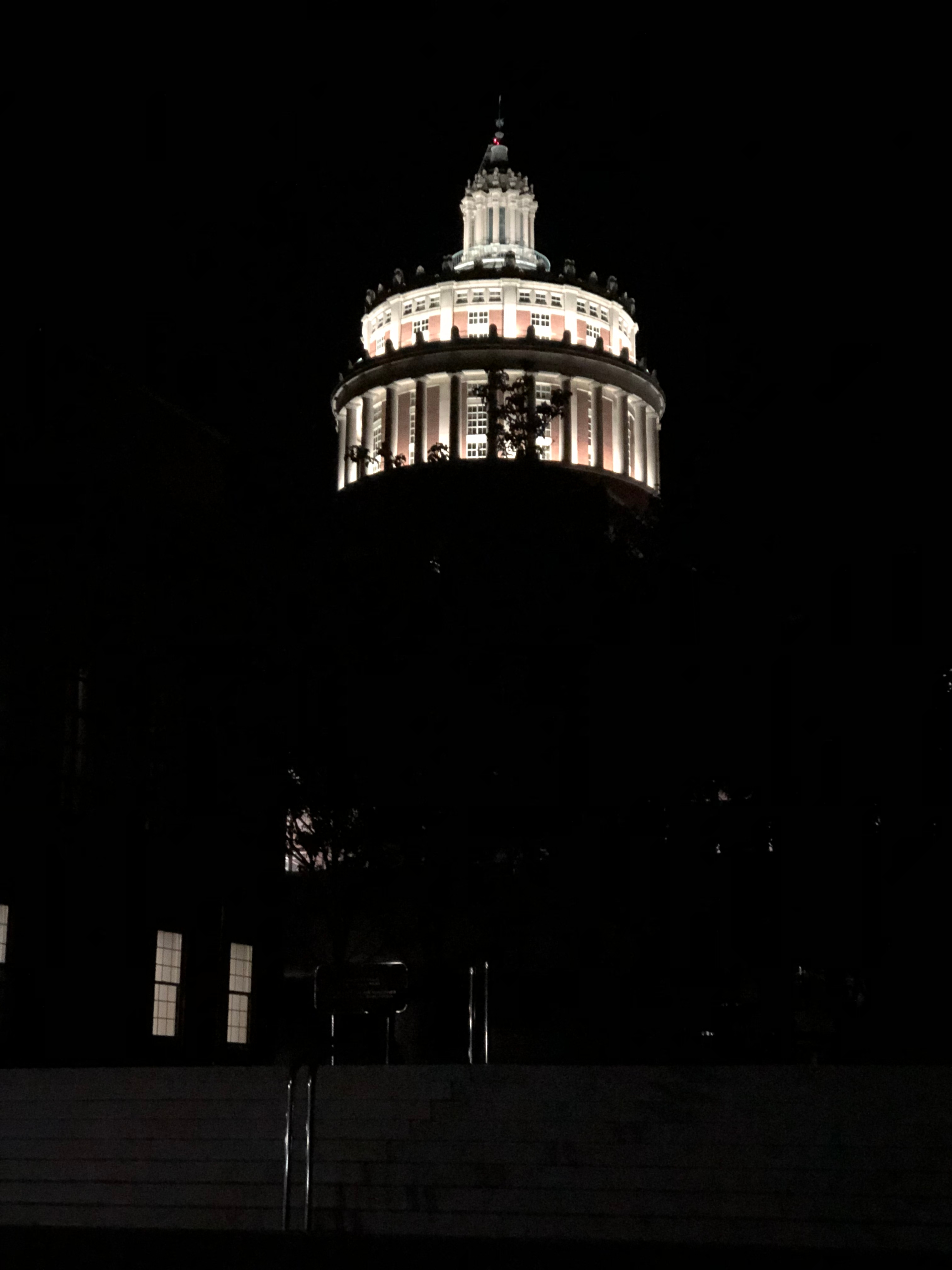 rush rhees library tower lit up at night