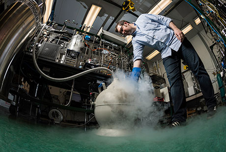 A PhD Student fills the "onion" with liquid nitrogen to trap sample gas.